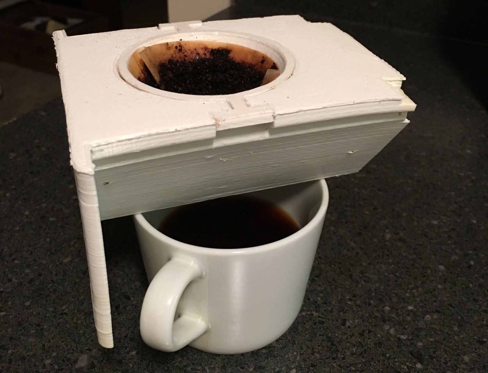  The first prototype brewing. Initially, when using plastic prototype brew cups, we were testing for concentration of flavor by observing the color saturation. Here, we see brews from both a Chemex (left) and the first prototype (right). 