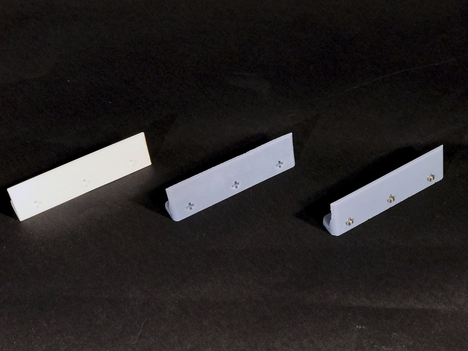  Some revisions of the brew cup drawer's rails with precision bearings set in the resin (far right). 